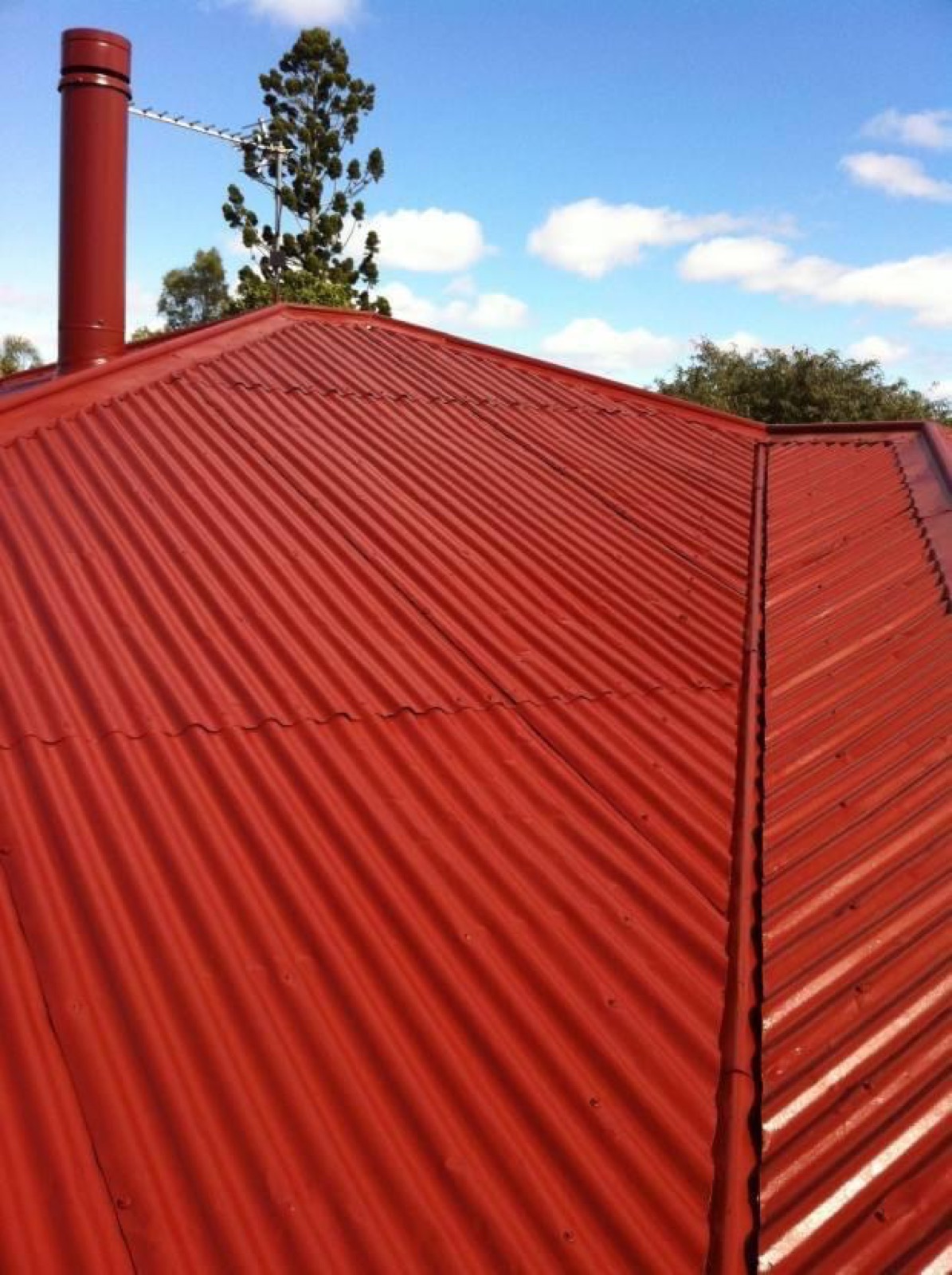Red galv roof restored with a fresh red coat